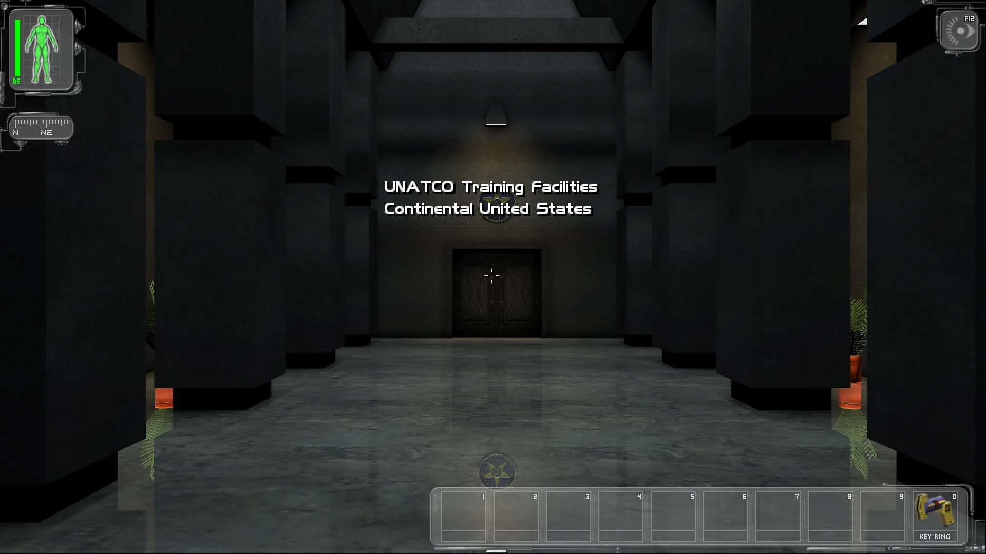 The UNATCO training lobby with its mirror floor and the location title